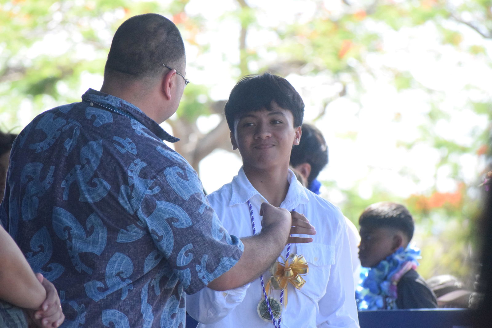 House Speaker Edmund S. Villagomez, left, fist-bumps eighth grader Manuelito John V. Erediano during the presentation of the certificates of promotion.