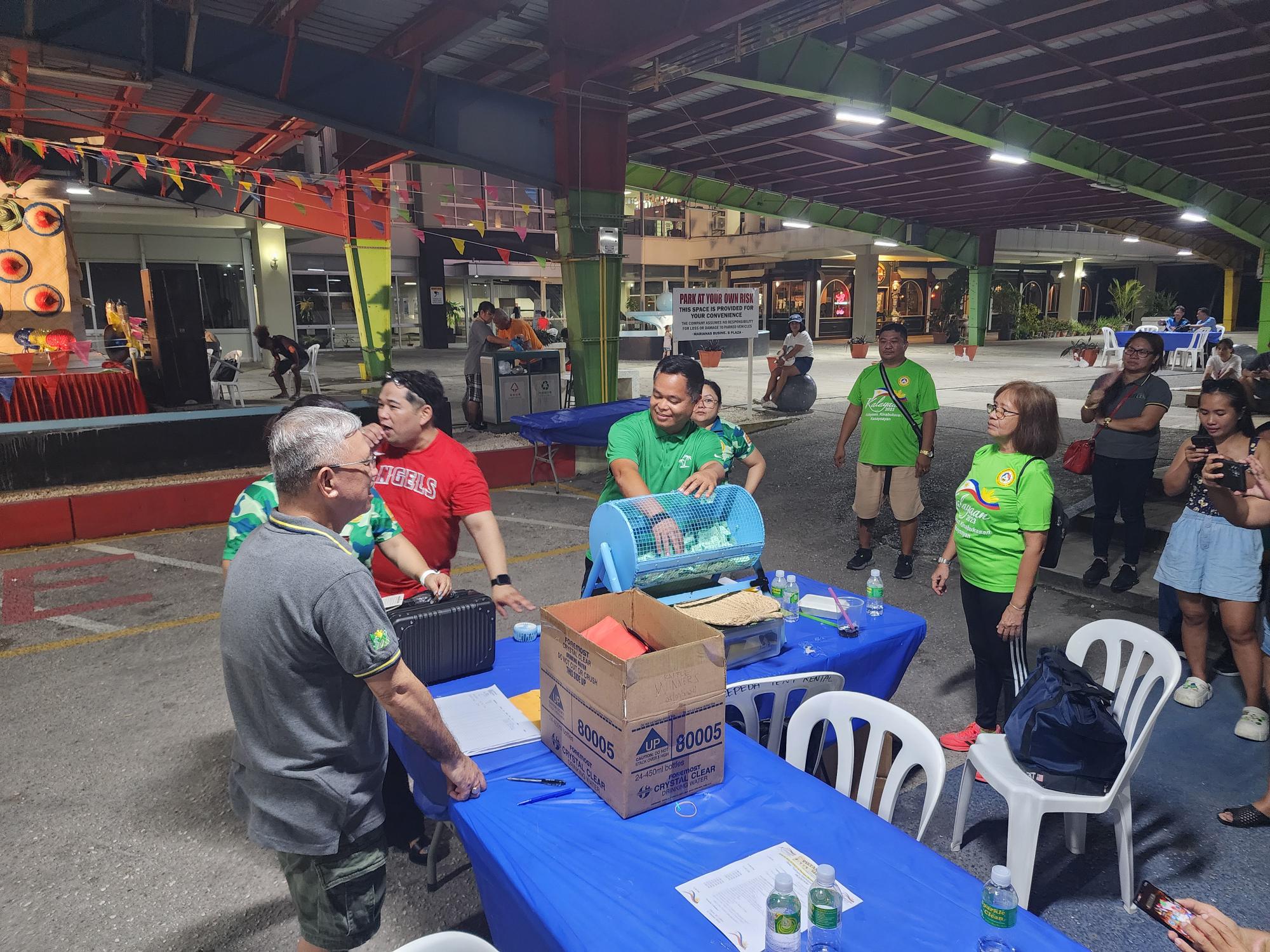 Marcelo Masilungan of Supertech Foundation draws one of the winning raffle tickets.