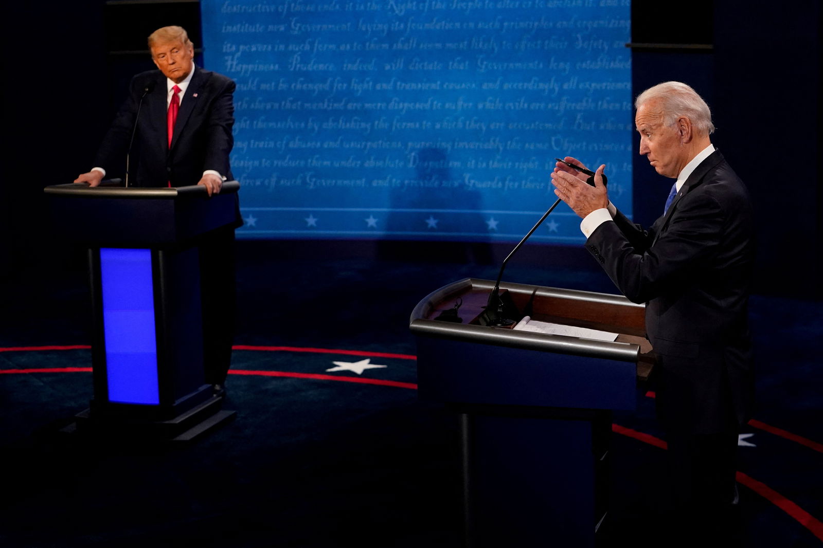 Democratic presidential candidate Joe Biden answers a question as then-President Donald Trump listens during the second and final presidential debate at the Curb Event Center at Belmont University in Nashville, Tennessee, Oct. 22, 2020.