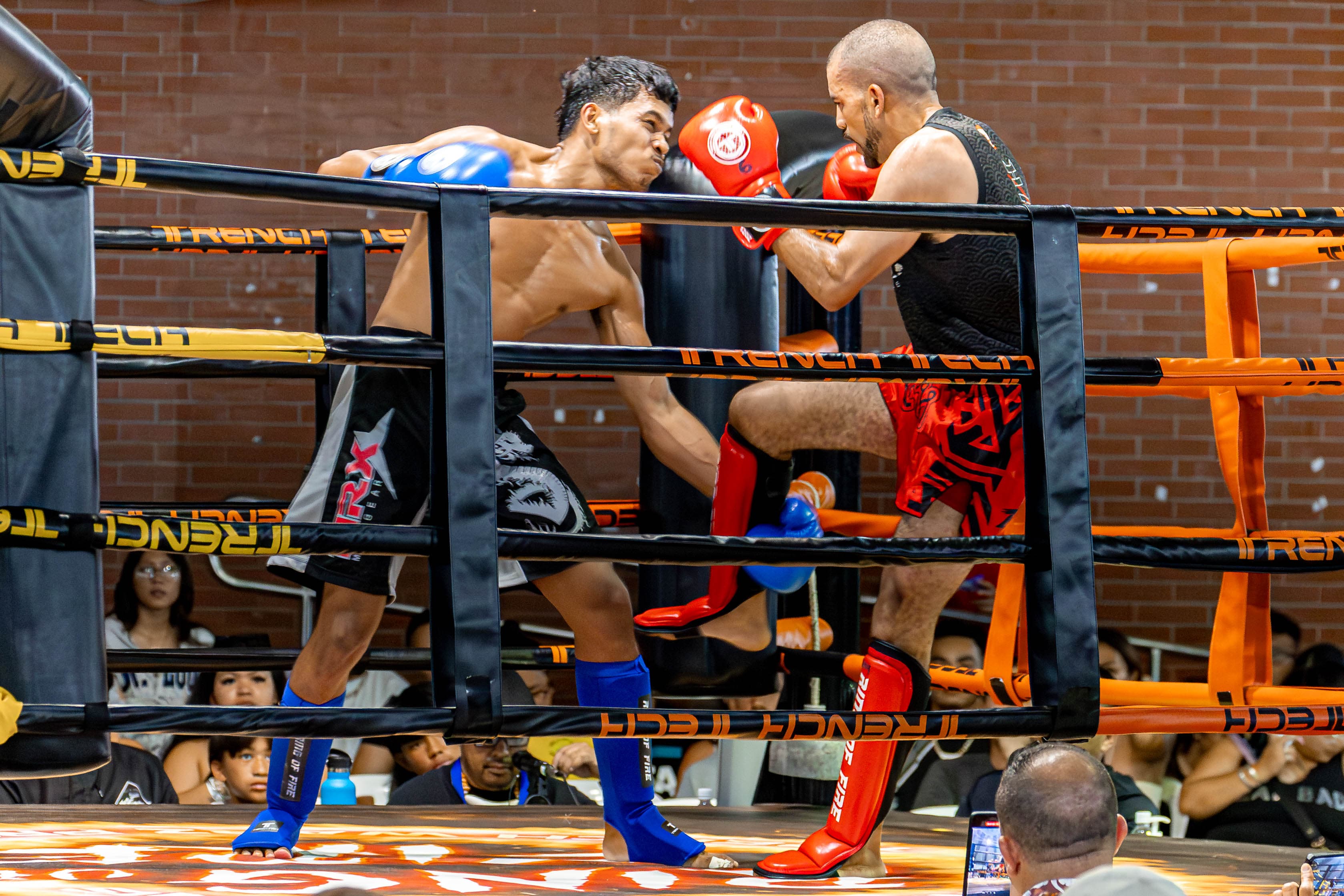 Tryese Bokuku winds up for the counter punch as he holds the leg of Jimmy Polk during a kickboxing bout in the main card of the Ring of Fire 2 at Garapan Central Park on Saturday.