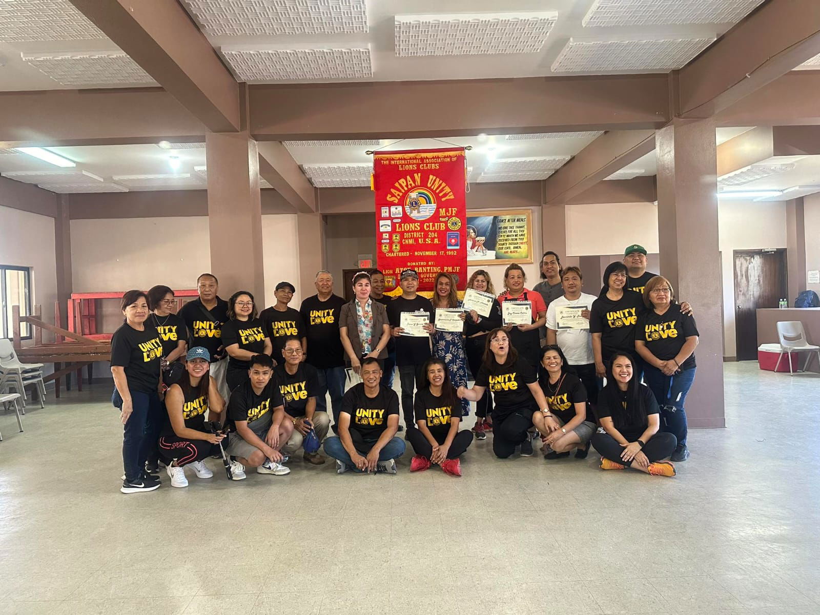The participating hair stylists pose for a photo with the officers and members of the Saipan Unity Lions Club at the Daidai Social Hall on Sunday.