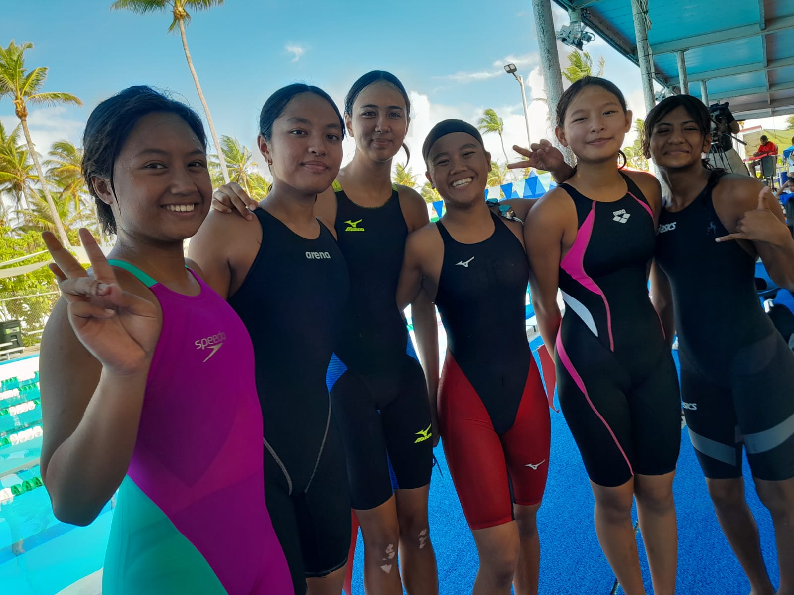 Team Marianas’ female swimmers pose for photo after their preliminary races Monday in the 2024 Micronesian Games in Kwajalein, the Marshall Islands.