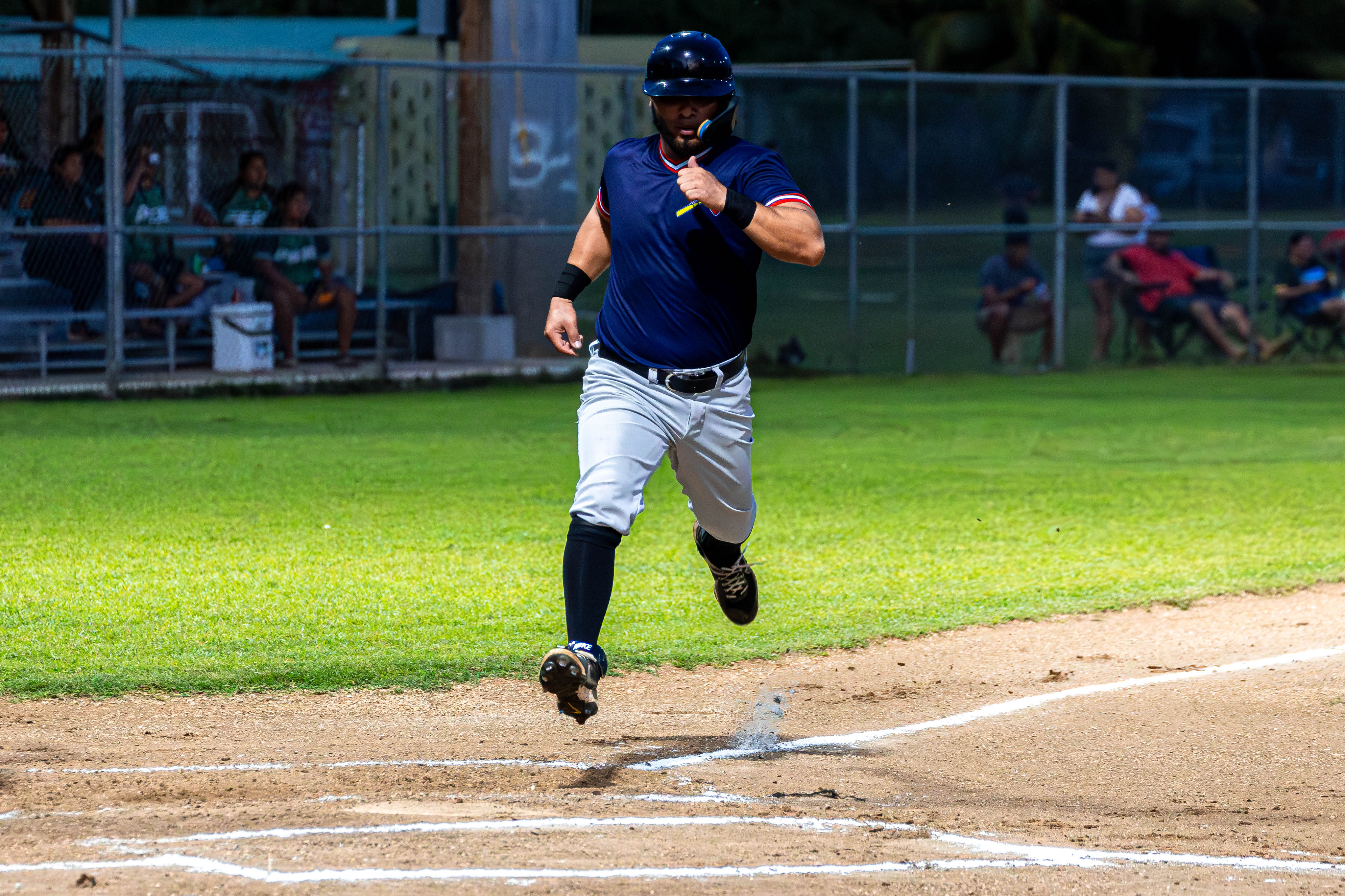 The Cardinals' #52 Tenorio runs in and scores for his team.