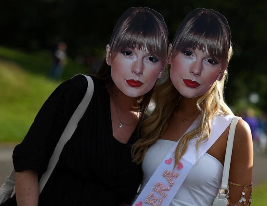Taylor Swift fans pose for a photo wearing face masks ahead of her concert at Anfield Stadium, in Liverpool, Britain, June 14, 2024.