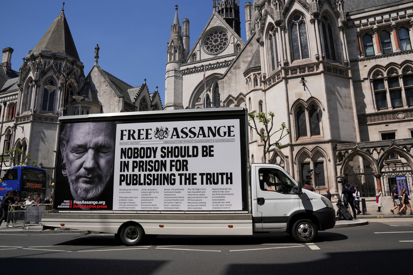 A car with a message in support of WikiLeaks founder Julian Assange drives in front of the High Court, on the day of an extradition hearing of Julian Assange, in London, Britain, May 20, 2024.