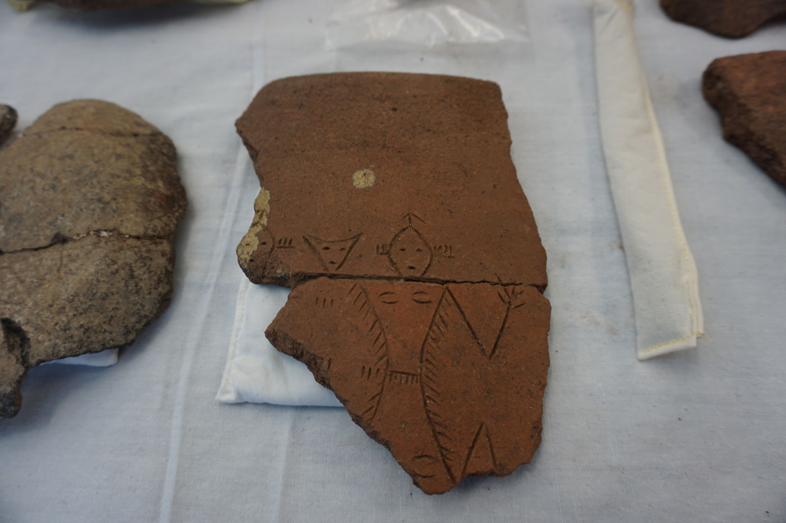 Human figures are depicted on a pottery shard in the Hornbostel Collection