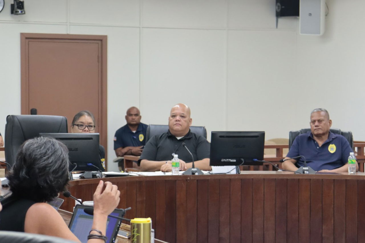 Department of Public Safety Commissioner Anthony Macaranas, center, Director of Police Aniceto Ogumoro, right, and Director for Administration Kay Inos, left, listen to Rep. Marissa Flores, back to the camera, during a budget hearing conducted by the House Ways and Means Committee in the House chamber on Tuesday.