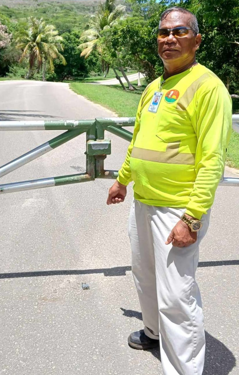 Community volunteer and Parks and Recreation staffer Max Aguon points to the broken padlock on the ground near the gate to the Grotto entrance in Marpi.