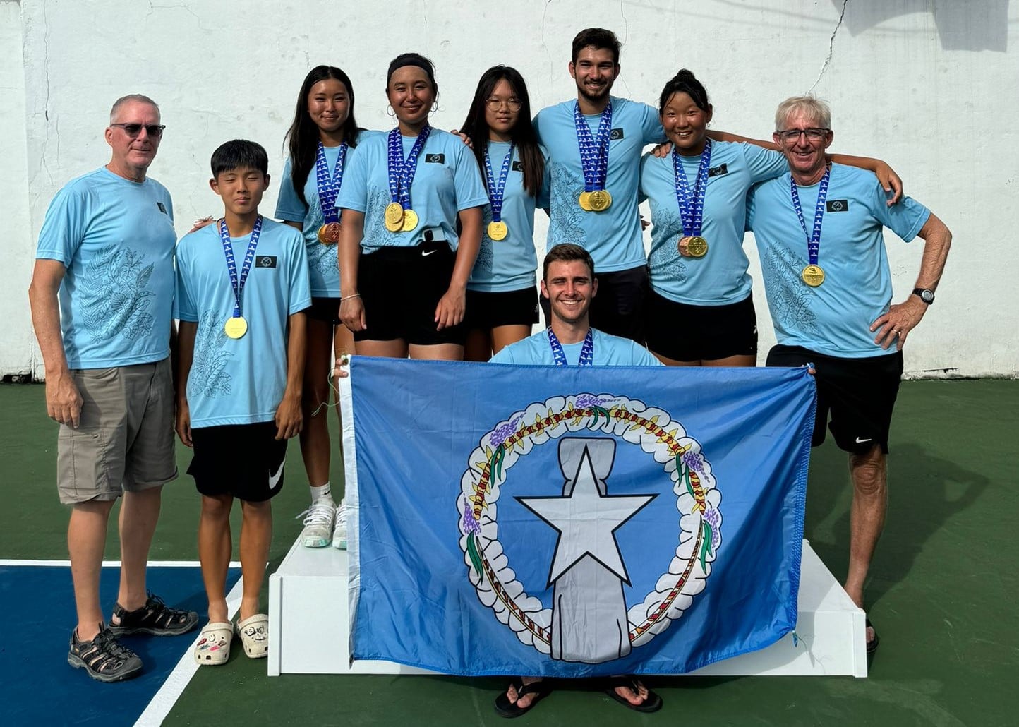 The NMI National Tennis Team players and officials pose for a group photo after sweeping the gold medals in the tennis competition in the 2024 Micronesian Games in the Marshall Islands.