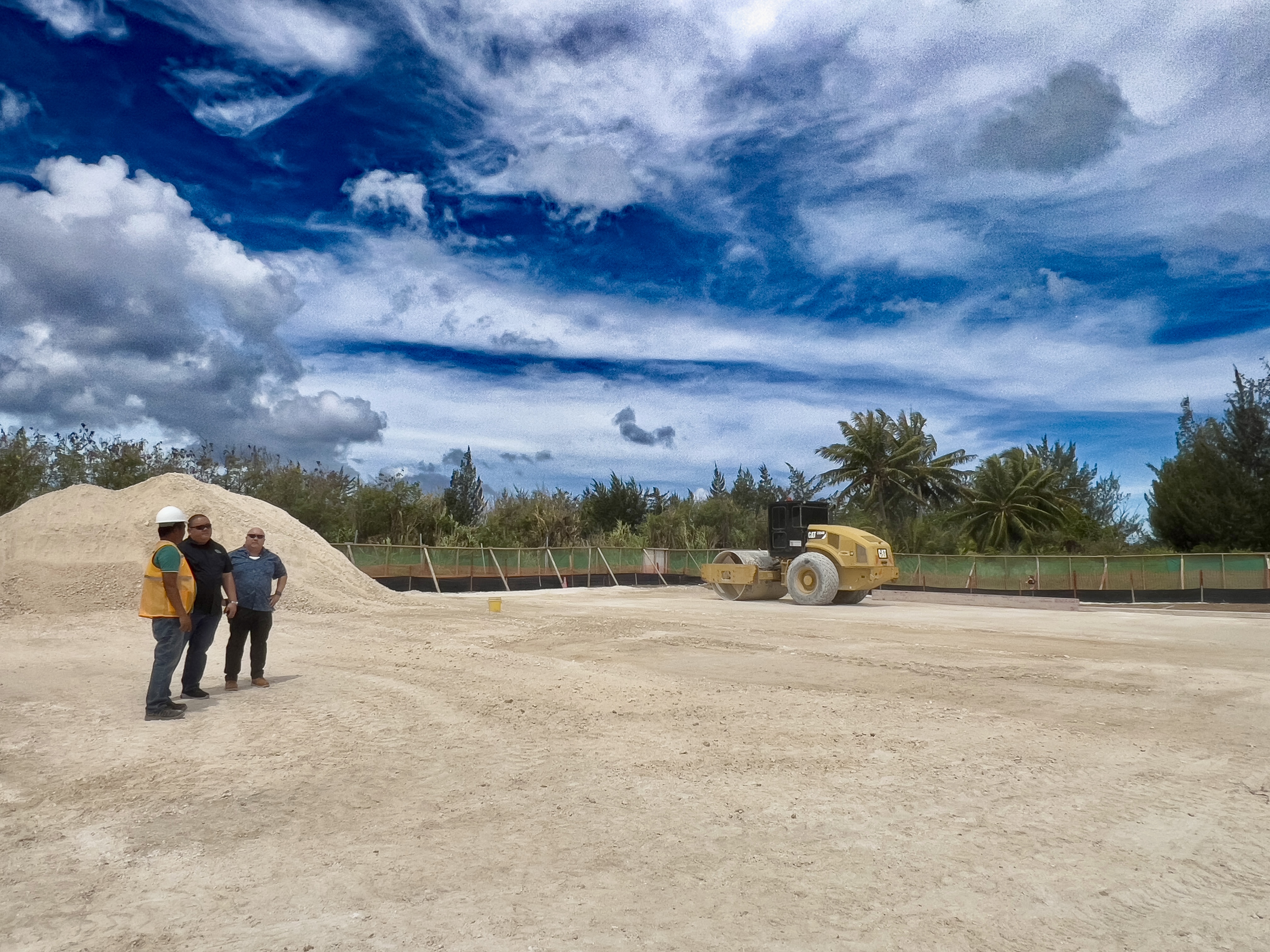 Commissioner of Education Dr. Lawrence F. Camacho, right, and Associate Commissioner for Administrative Services Eric Magofna, center, are accompanied by Roland Cervania, field supervisor of Core Plus, a subcontractor for the ongoing clearing work, at the site for Hopwood Middle School’s new modular buildings on Friday, May 31.  (Story on page 9)