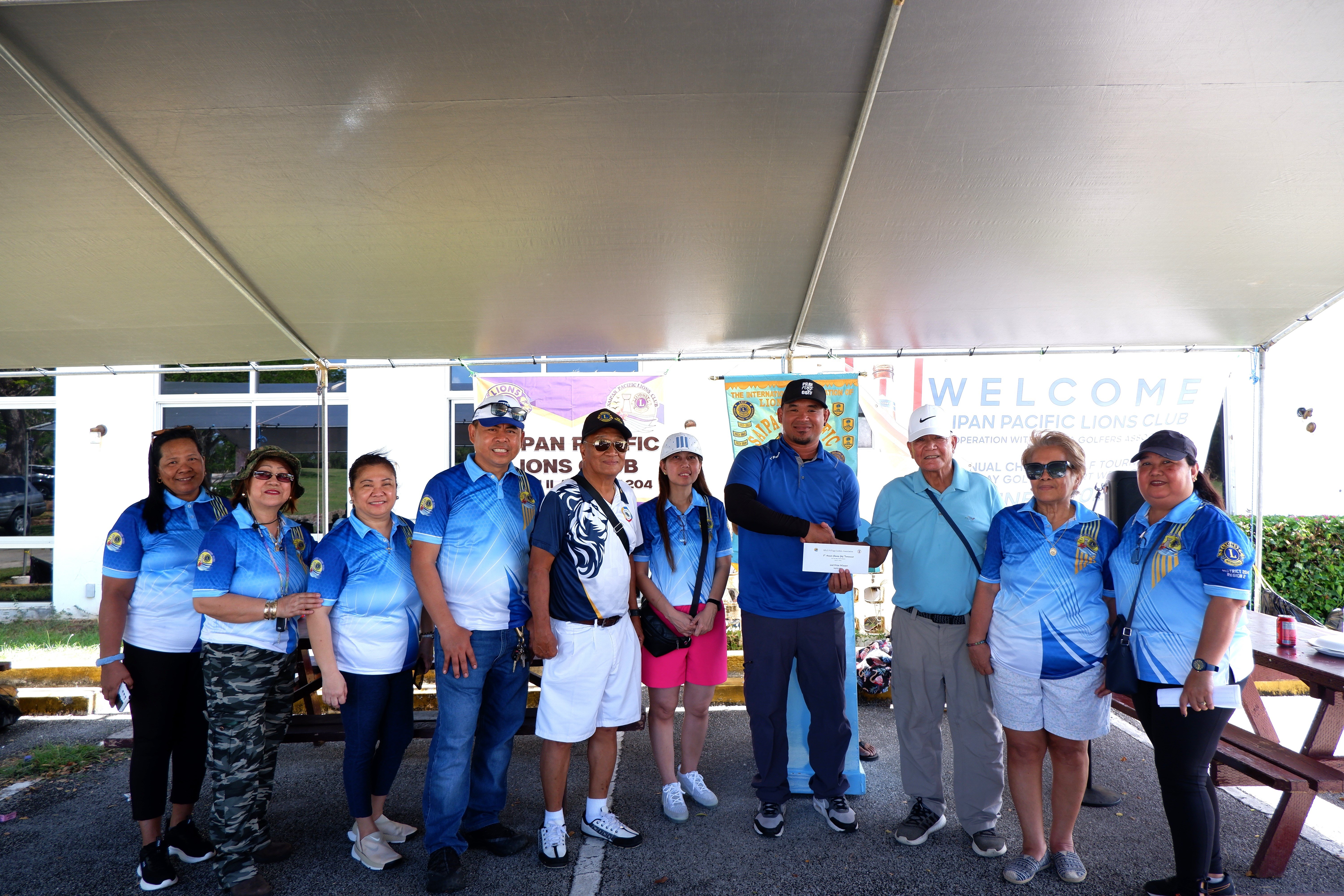 Peter Mendiola accepts the prize on behalf of tournament winner Father James Balajadia, who had to leave early for a prior appointment.
