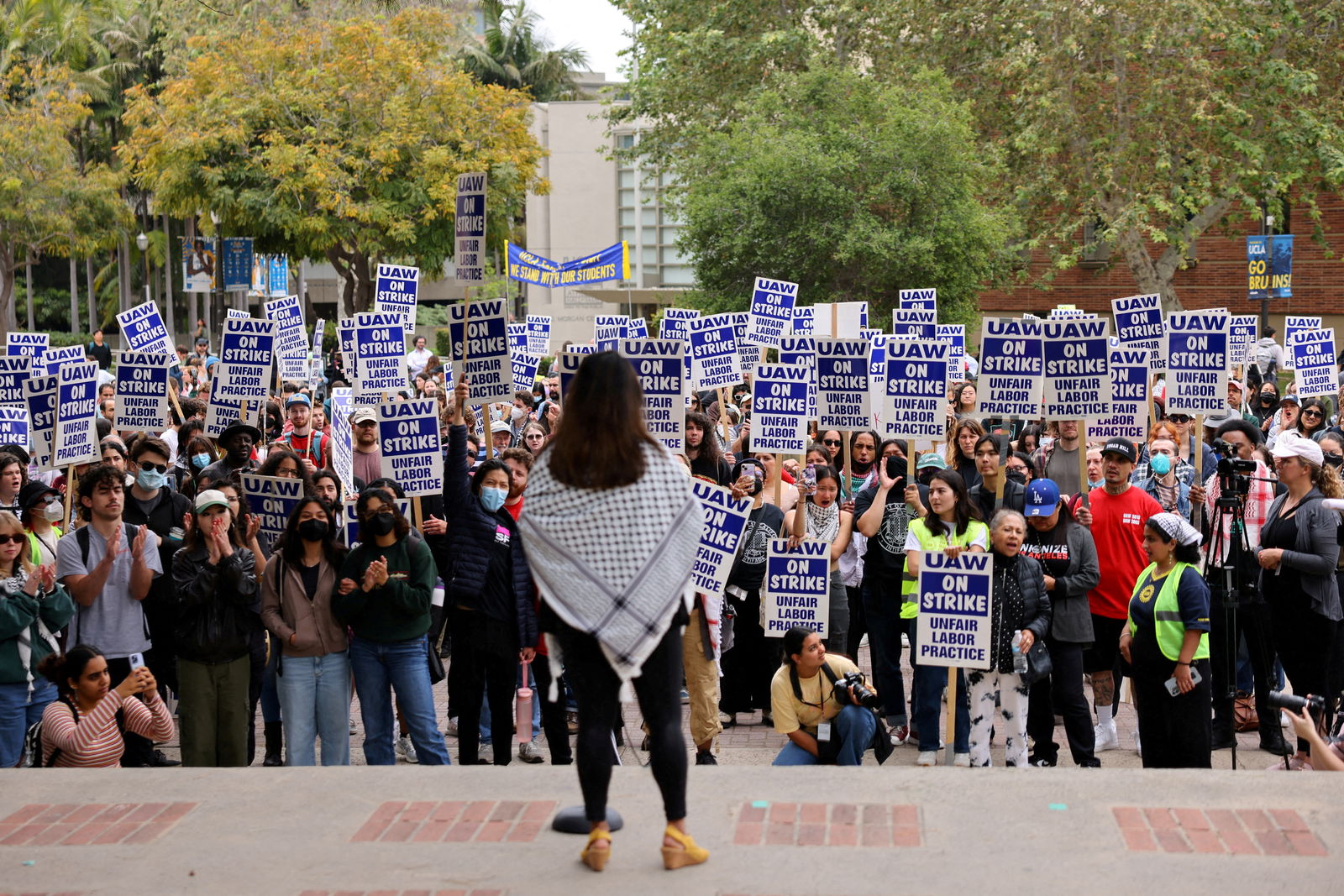 Unionized academic workers, upset about the University of California's response to pro-Palestinian protests at various campuses, hold placards as they strike at the University of California Los Angeles in Los Angeles, California, May 28, 2024.