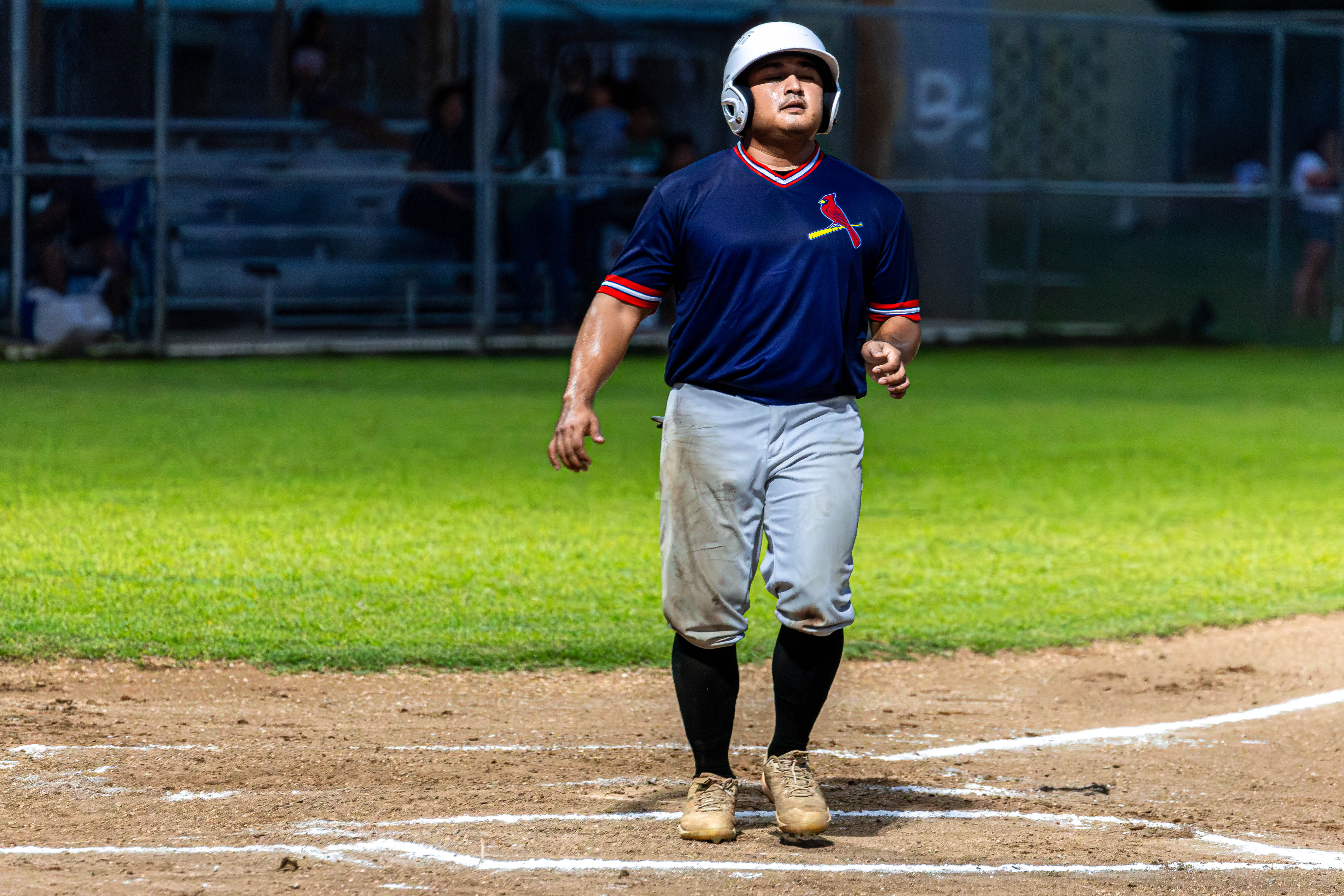 The Cardinals' #9 Saralu scores a run for his team.