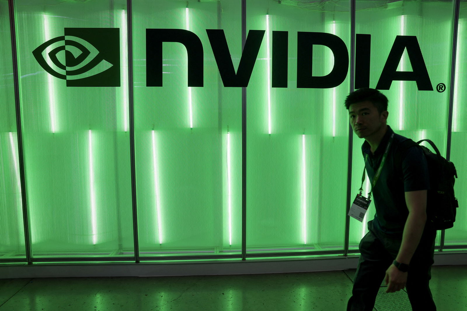 A person walks pass a Nvidia logo at Computex in Taipei, Taiwan, June 5, 2024. 