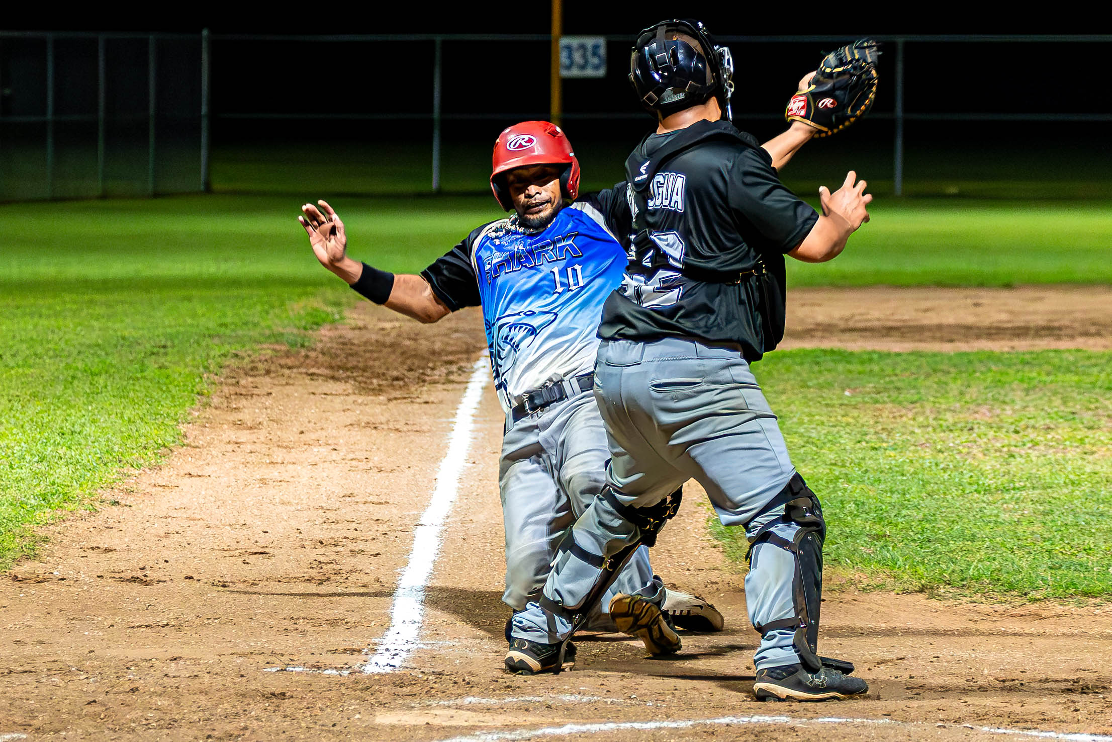 The Blue Sharks’ Cartfield Sablan slides in an attempt to beat the tag during a game in the 2024 Tan Holdings Saipan Baseball League at the Francisco "Tan Ko" Palacios Baseball Field on Friday.