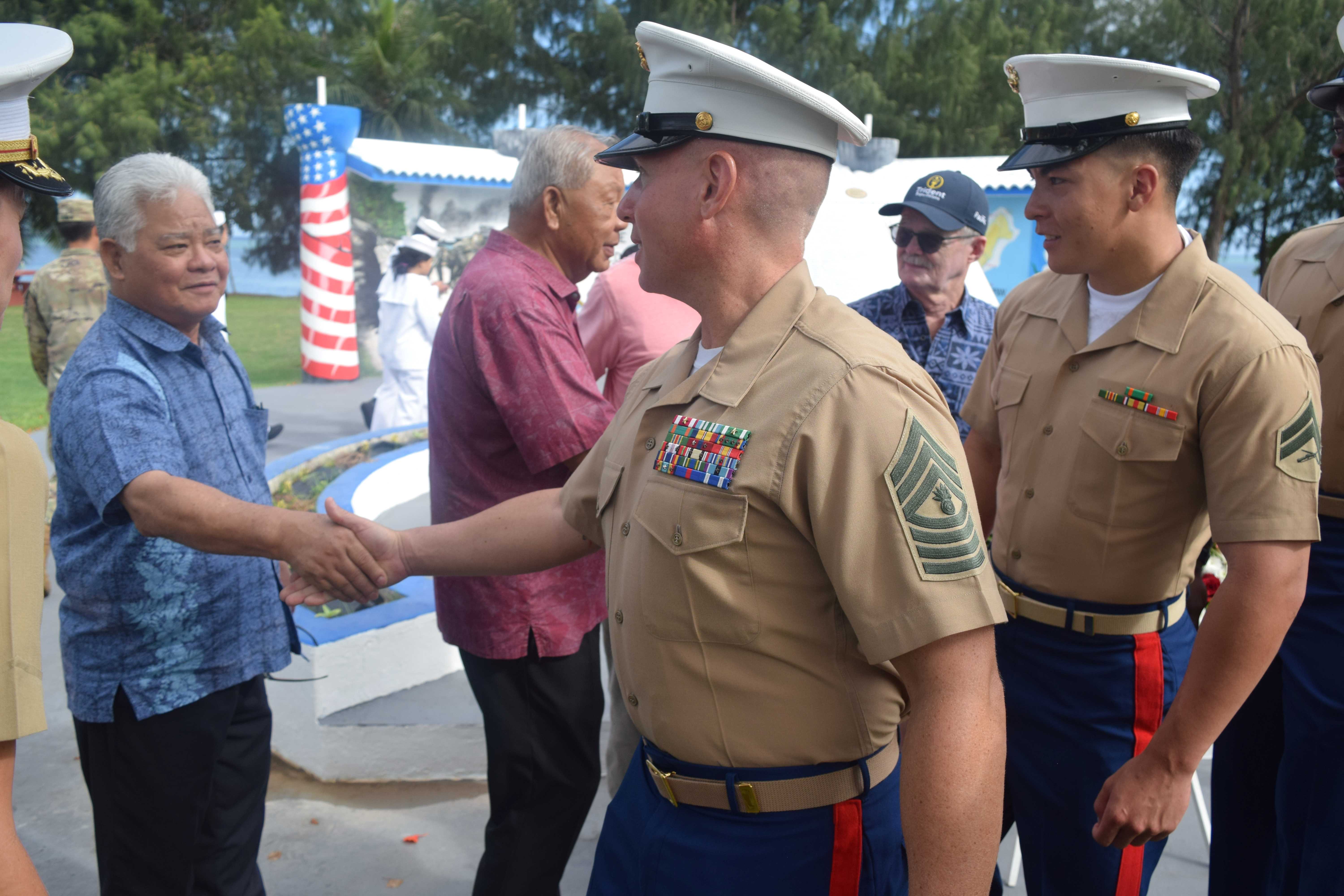 Gov. Arnold I. Palacios and Lt. Gov. David M. Apatang shake hands with the U.S. Marines who took part in the reenactment of the U.S. landing on Invasion Beach during the Battle of Saipan in Susupe on Saturday, June 15, 2024.