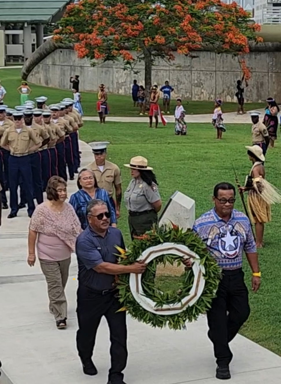 Tinian Mayor Edwin Aldan and Saipan Mayor Ramon "RB" Camacho bring a wreath to the Marianas Memorial, which honors the Chamorro and Carolinian civilians who died during the Battle of Saipan.