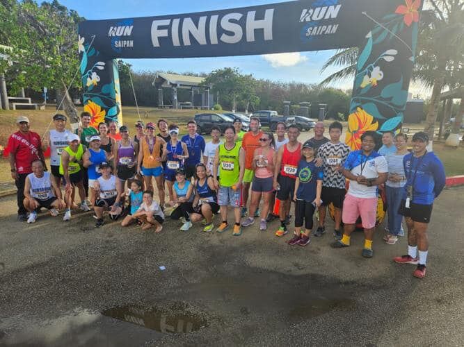 Participants of Run Saipan's 3rd Annual Grotto 10K '24 pose for a photo at the Grotto on the Saturday morning.