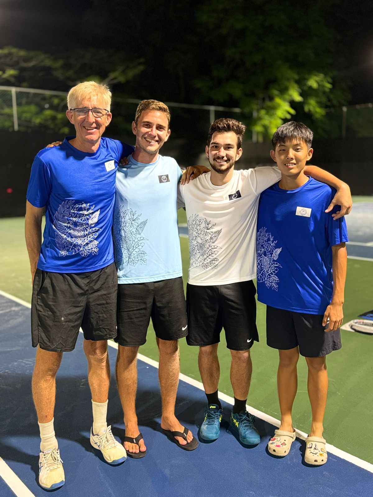 Coach Jeff Race and players Colin Ramsey, Robbie Schorr and Si Woo Lee pose for a photo before the gold medal game against Guam in the team event.