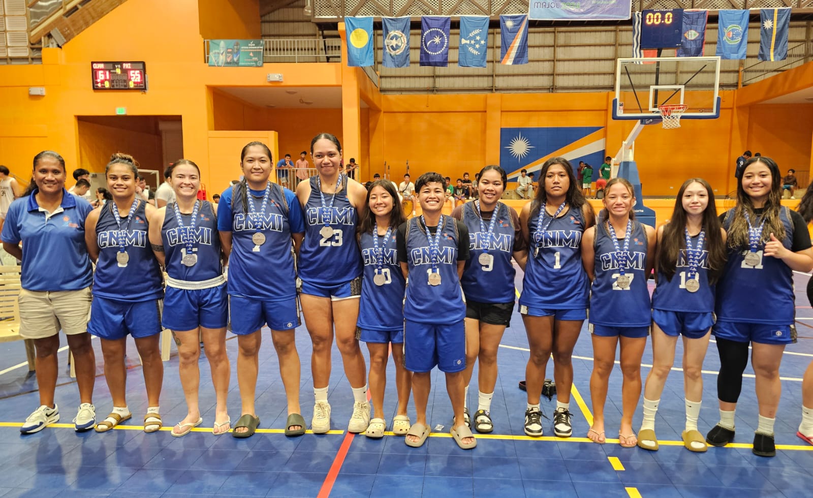 The NMI Women's National Basketball Team players and coaches receive their silver medal.