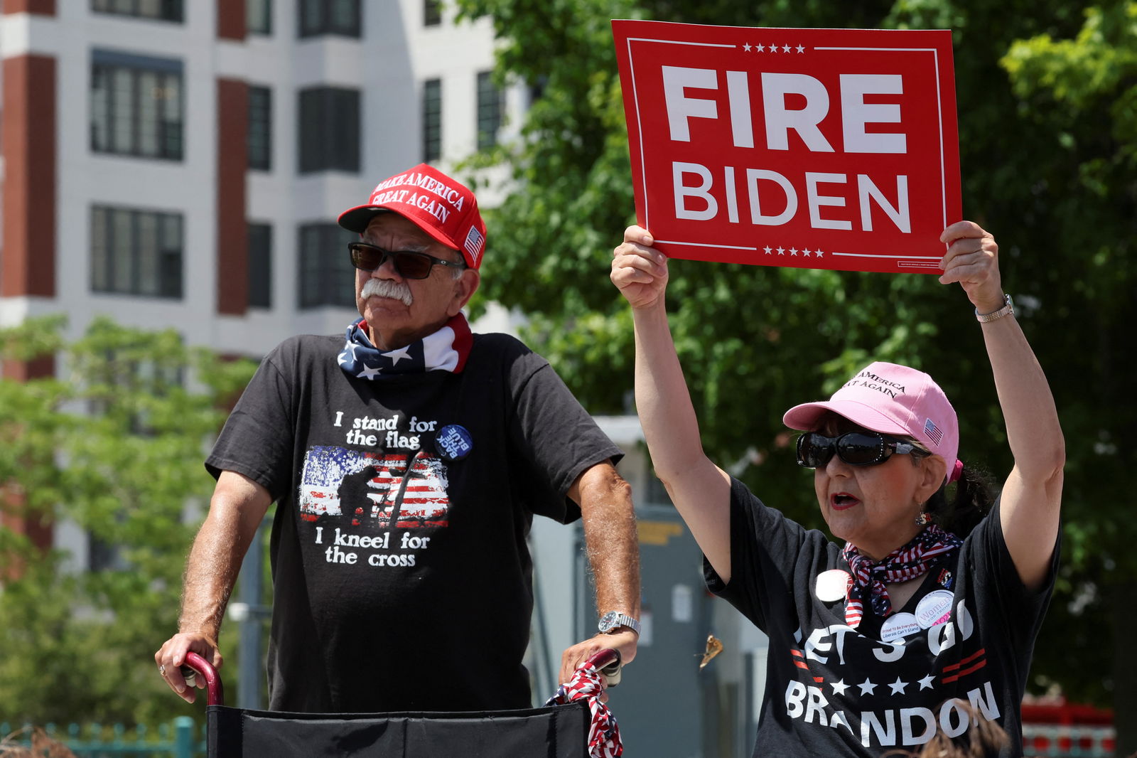 A woman holds a placard during a campaign event held by Republican presidential candidate Donald Trump in Racine, Wisconsin, June 18, 2024. 