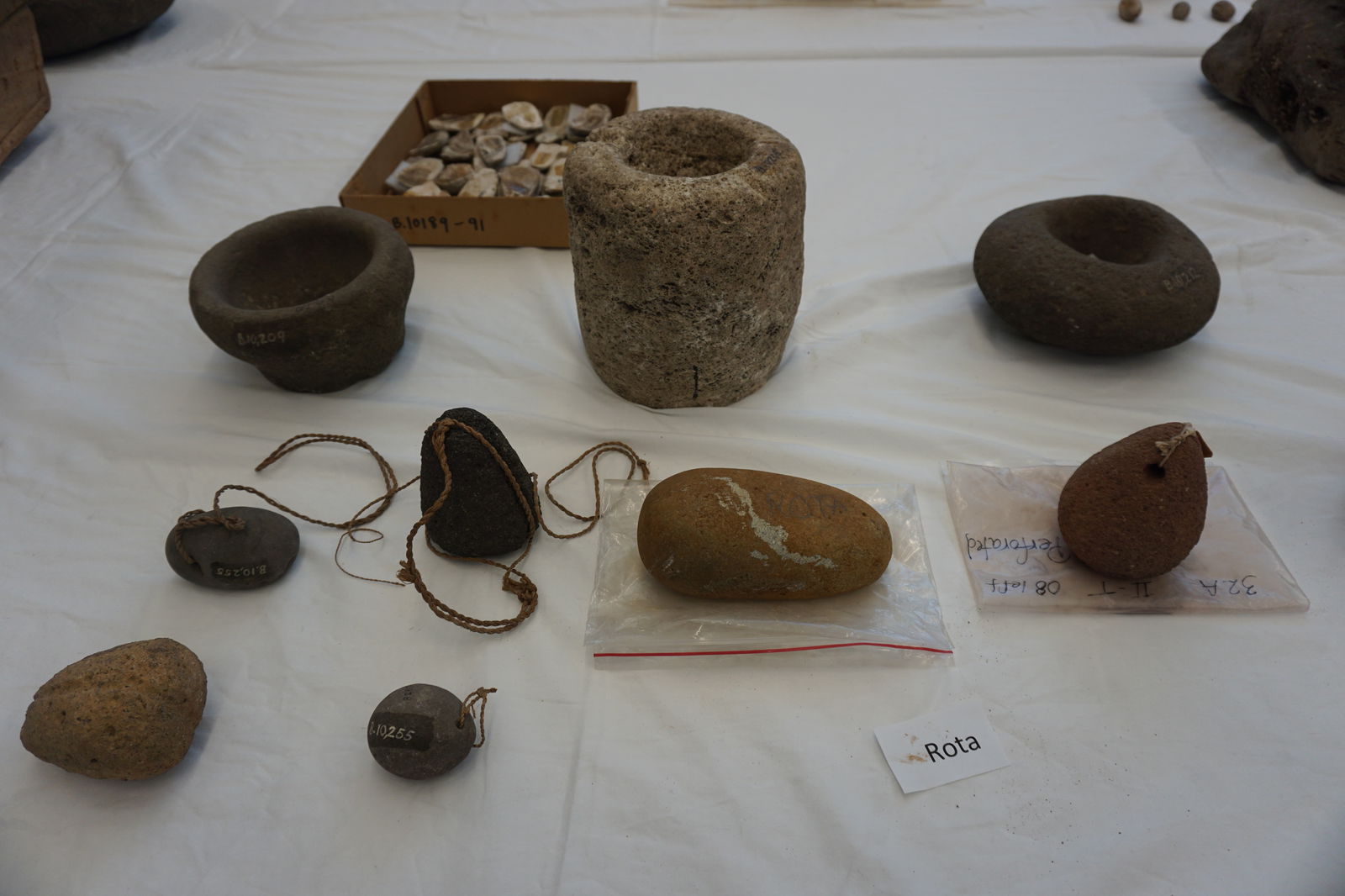 Upper row, a few stone mortars. Second and third row, stone sinkers. These artifacts were all taken from Rota.