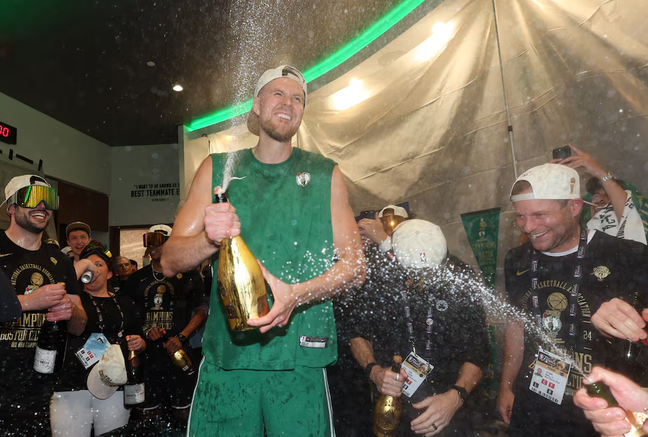Boston Celtics center Kristaps Porzingis (8) celebrates in the locker room after winning the 2024 NBA Finals against the Dallas Mavericks at TD Garden in Boston, Massachusetts, June 17, 2024.