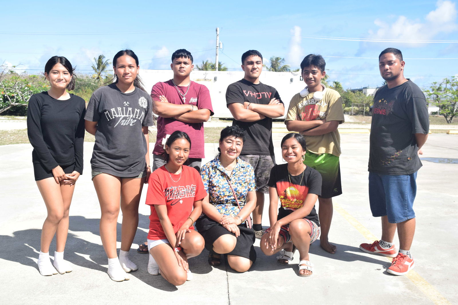 Saipan Awaodori founder and Kinpachi Restaurant president Misako Kamata, center kneeling, and the Saipan Awaodori team members pose for a photo while taking a break from practice at the Koblerville Youth Center on Monday.