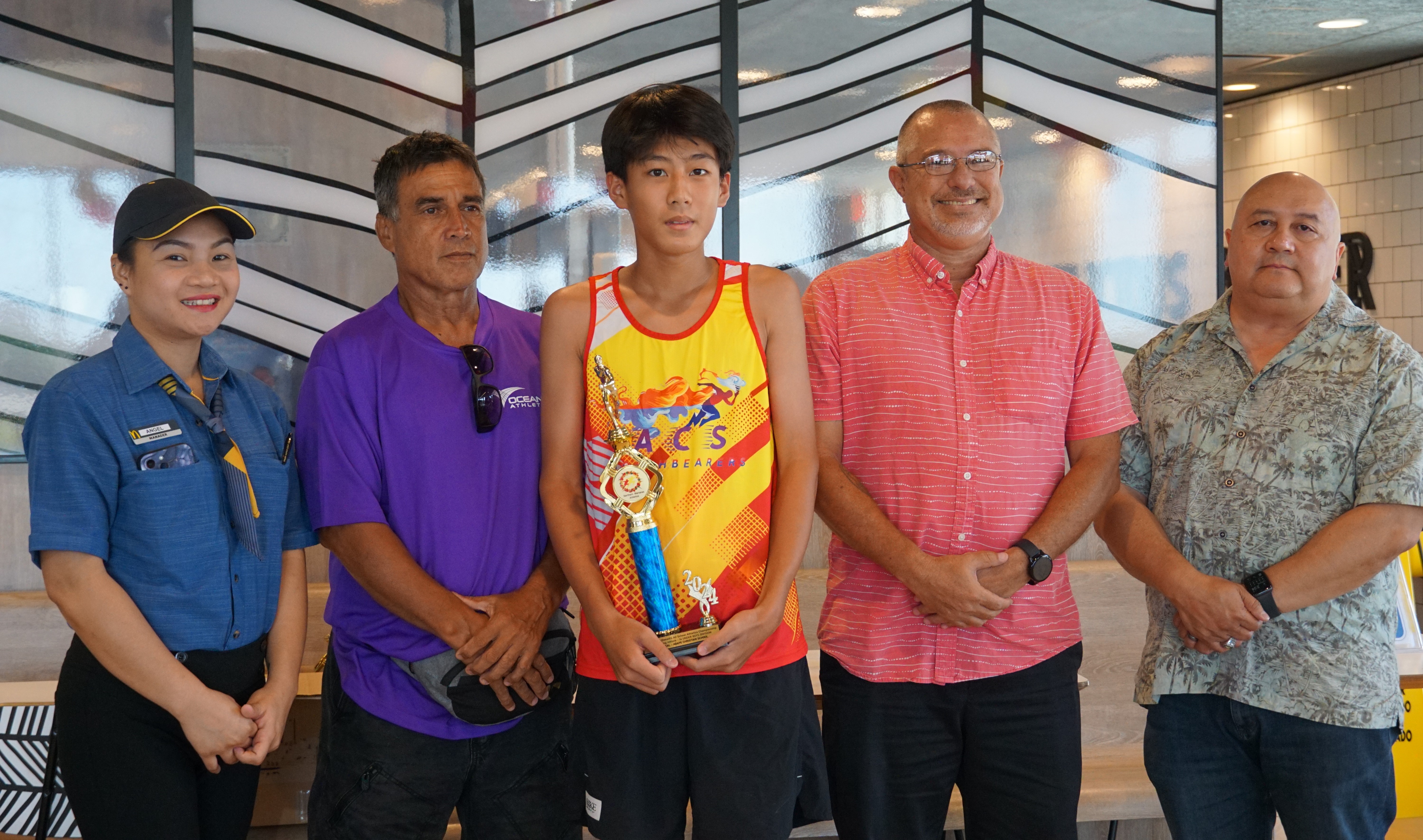 U14 male MVP Raffy Cai poses for a photo with a McDonald's Saipan employee, Northern Marianas Athletics' Elias Rangamar, Board of Education member Greg Borja and Education Commissioner Dr. Lawrence F. Camacho during the McDonald's-PSS All Schools Track and Field (Athletics) SY23-24 awards ceremony at McDonald's Chalan Kiya on Thursday last week.