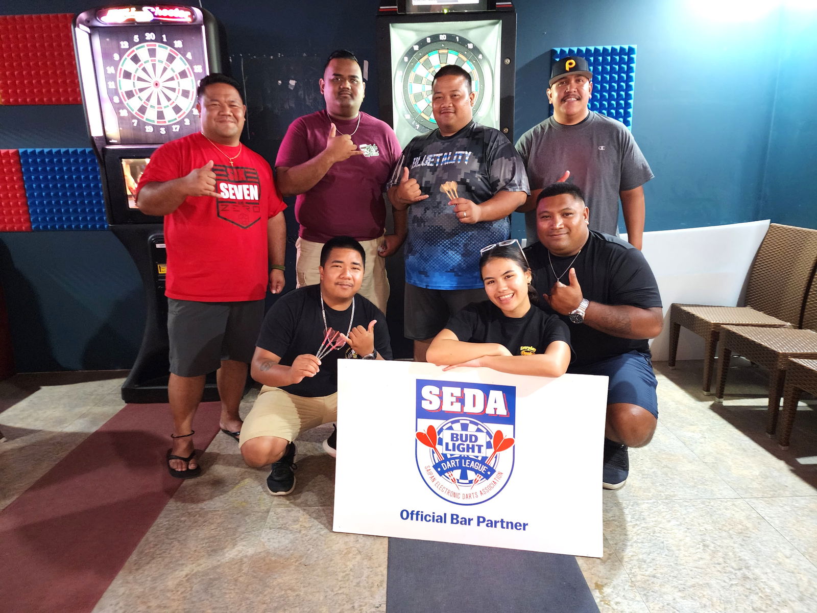 The Black 8 Savages pose for a photo after their victory against  the DPS True Enforcers in the Inter-Government Division of the 2024 SEDA Bud Light Dart League at the Black 8 Pool Bar on Friday.