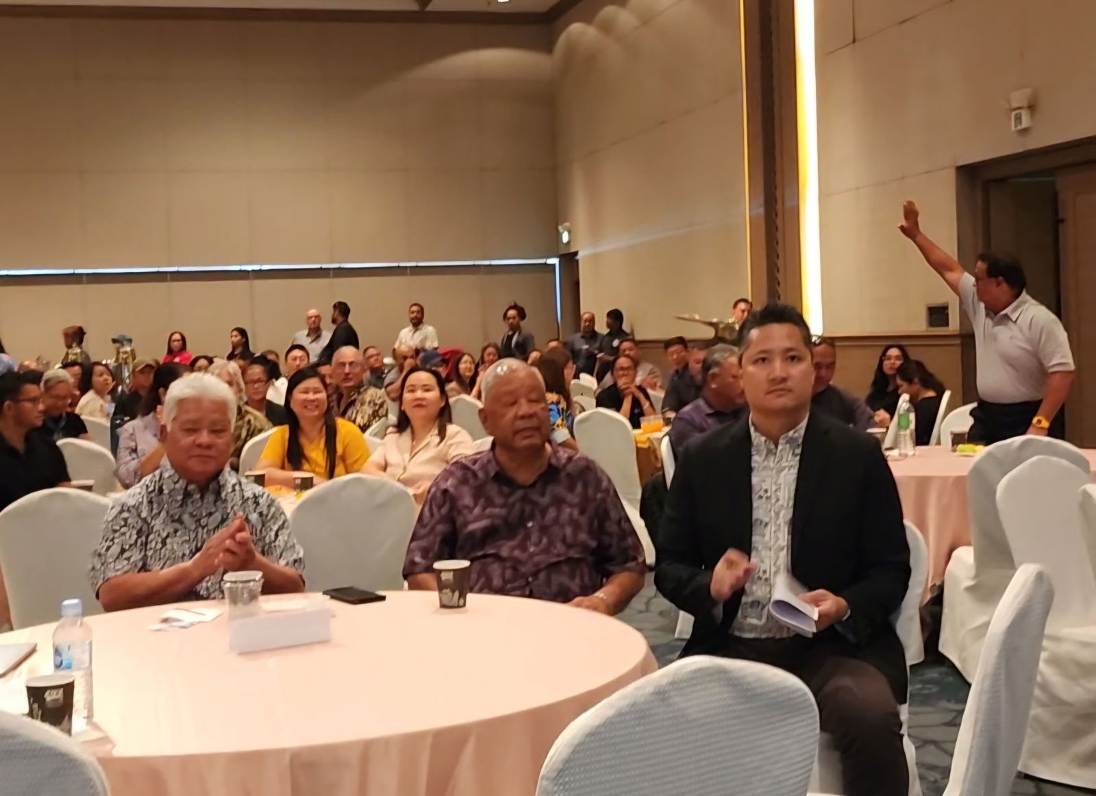 Marianas Visitors Authority Managing Director Christopher Concepcion with Gov. Arnold  I. Palacios and Lt. Gov. David M. Apatang during MVA’s membership meeting at Saipan World Resort on Thursday. In the background, Saipan Mayor Ramon "RB" Camacho waves as he is  introduced to the MVA members.