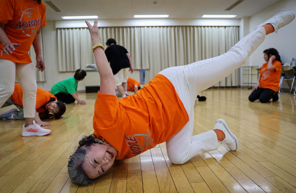 Saruwaka Kiyoshie, 74, a member of Japan's only breakdancing club made up of elderly citizens, Ara Style Senior, practices a dance move known as “chair freeze” during a practice session in Tokyo, Japan April 26, 2024.