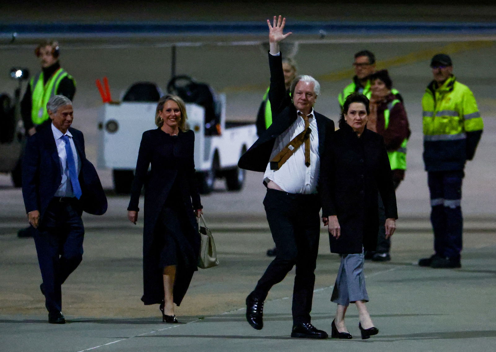 WikiLeaks founder Julian Assange waves as he arrives in Canberra, Australia, June 26, 2024. 