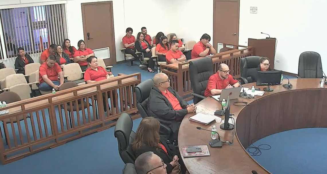 Northern Marianas College President Galvin S. Deleon Guerrero, EdD, 2nd right foreground, speaks to members of the House Ways and Means Committee while other NMC officials and staff listen.