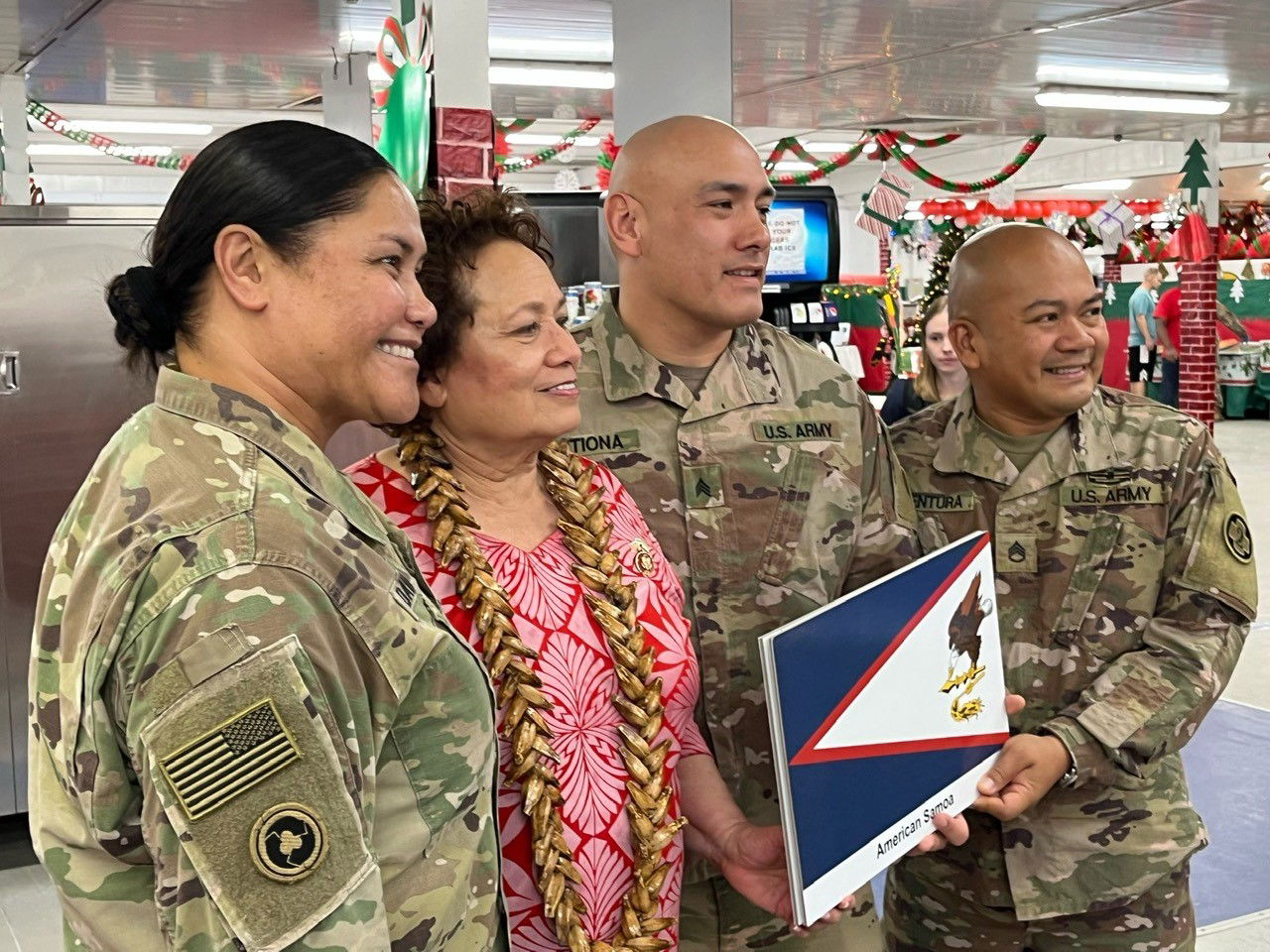 Amata poses for a photo with Samoan service members in Kuwait.