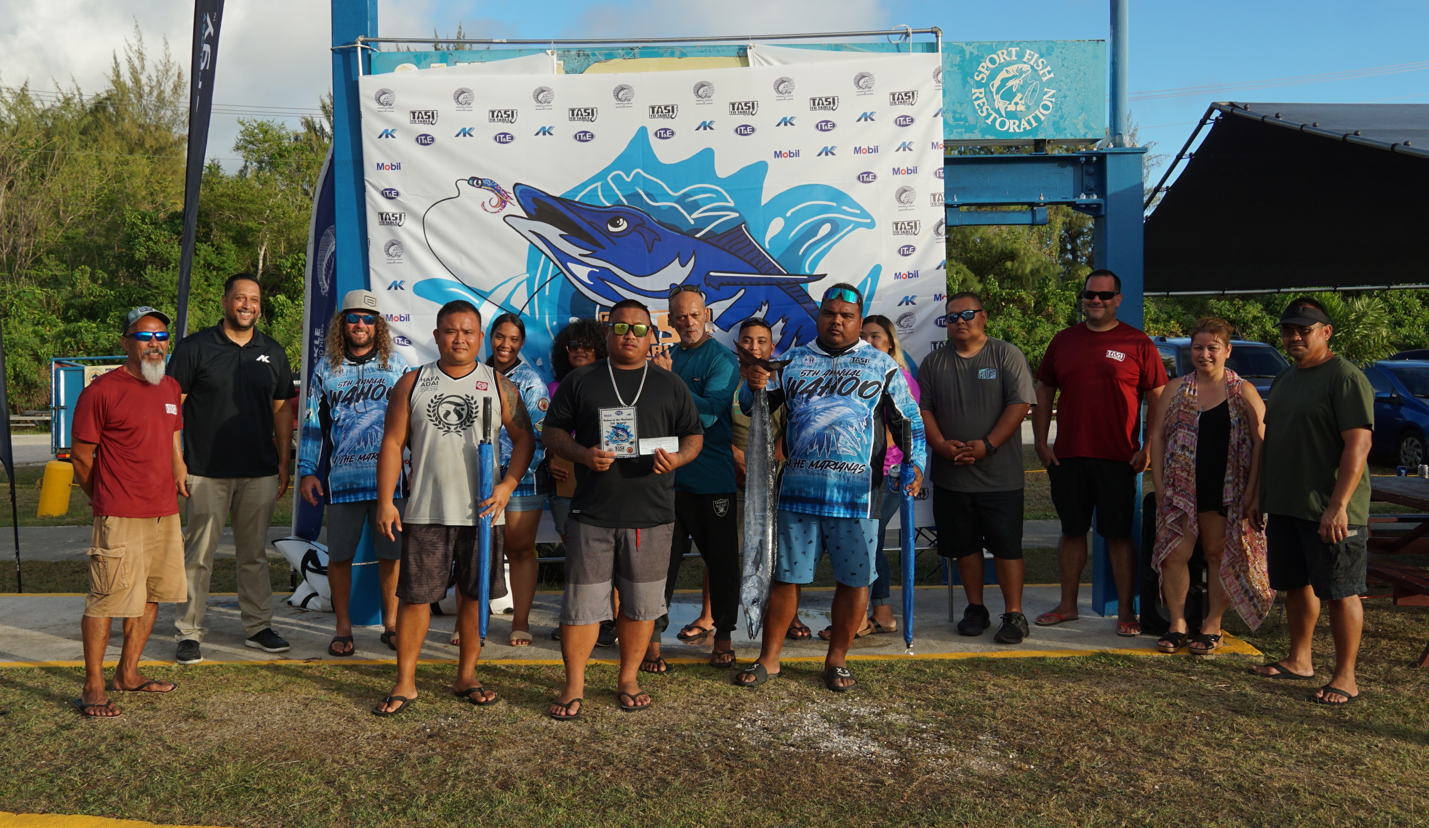The captain of crewmembers of Fangoti pose with the first-place trophy and Tasi To Table officials during the awards ceremony of Tasi To Table's 5th Annual Wahoo in the Marianas at the Smiling Cove Marina on Saturday.