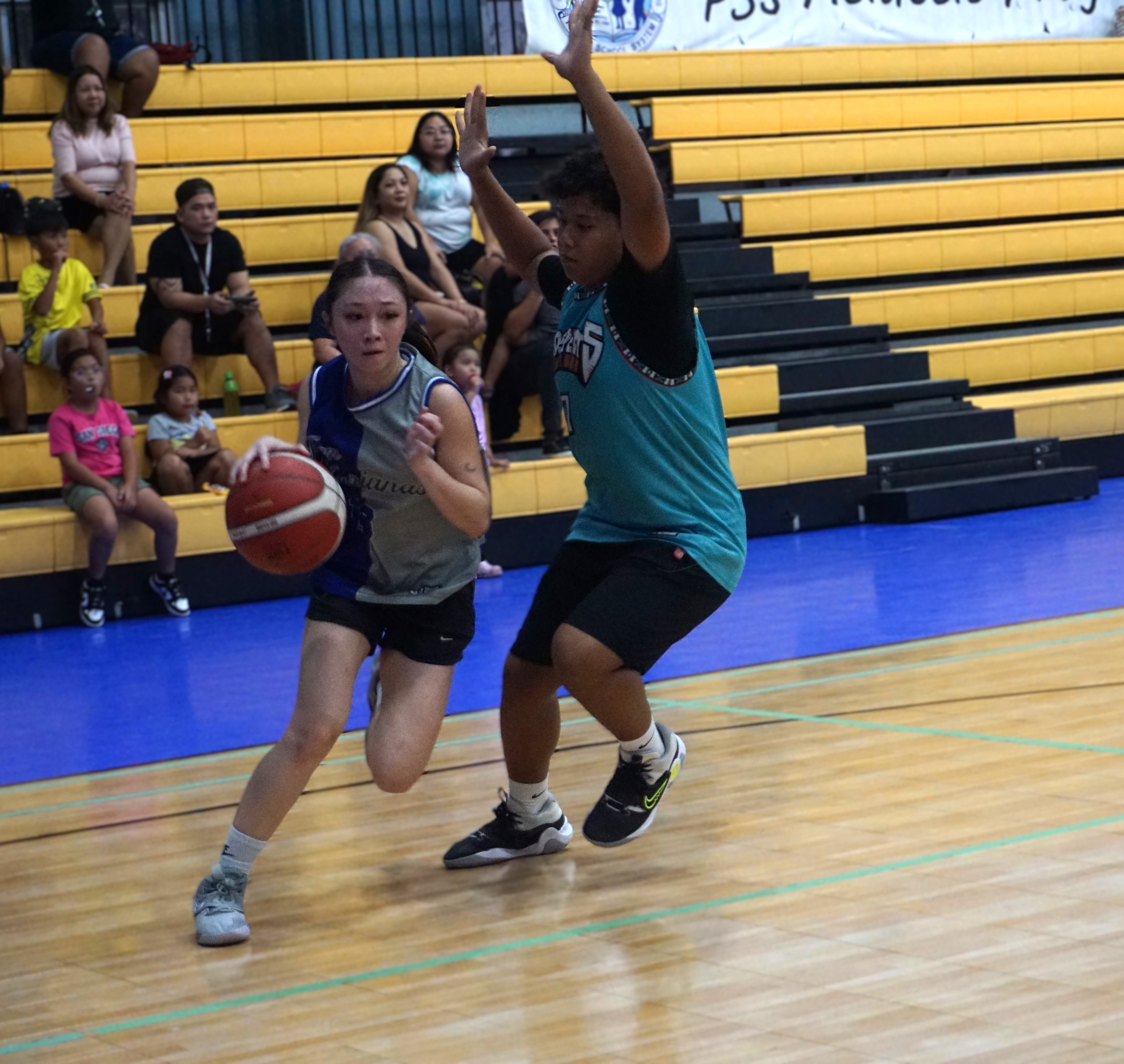Team Marianas' Kaia Travilla attempts to drive past a defender during a game in the Pokka Cup 2024 at the Ada gym.