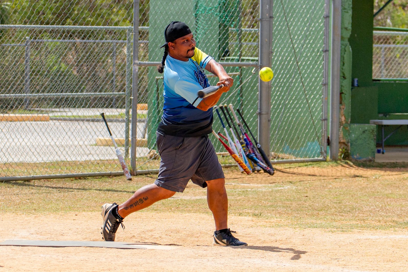 Asahi's Anson Jones connects a single during a game in the 2024 Belau Amateur Softball Association League at the Dandan baseball field.