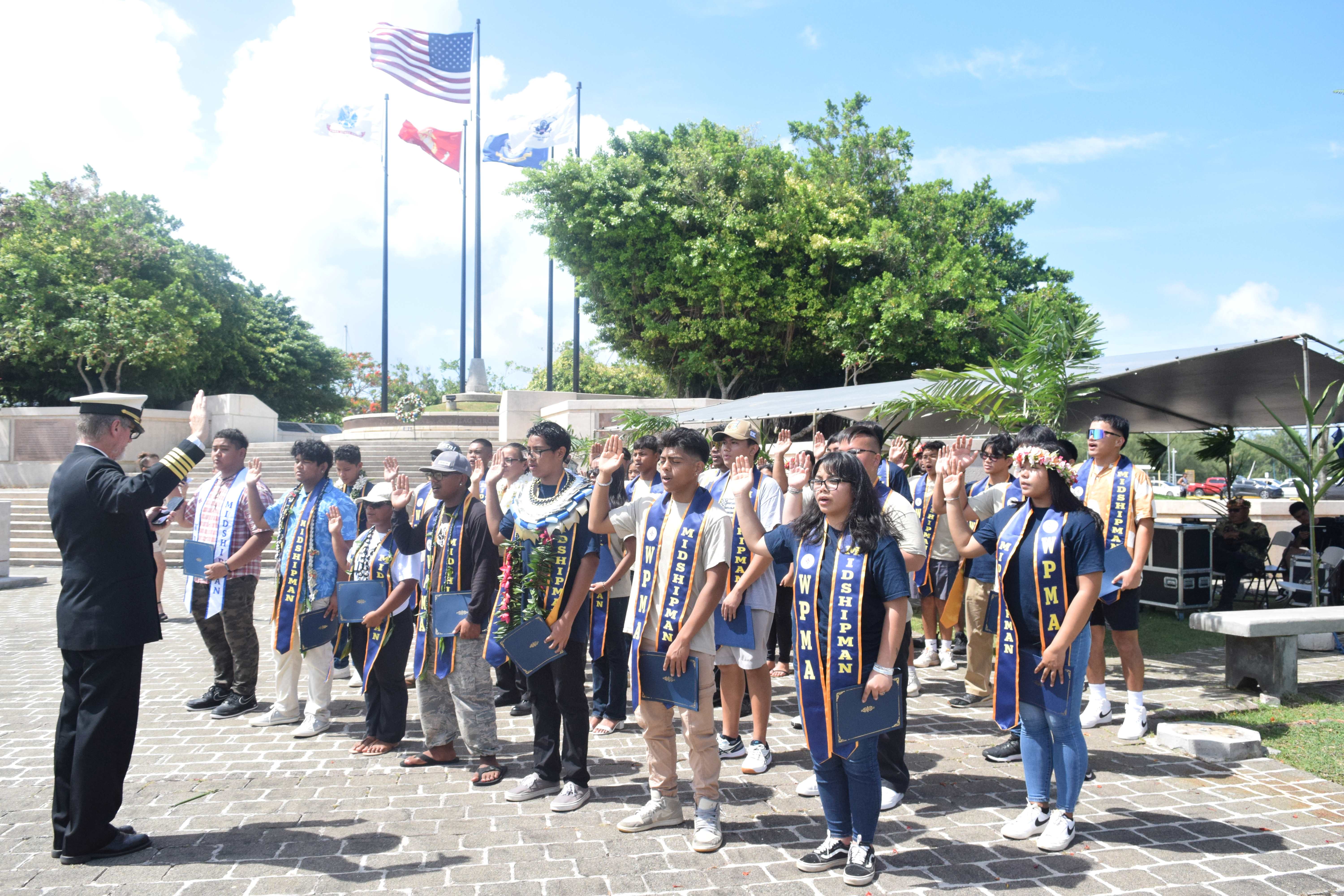 Western Pacific Maritime Academy Executive Director Capt. Michael Bacher administers the oath of office to 47 graduating midshipmen during a ceremony at the American Memorial Park Court of Honor on Saturday.