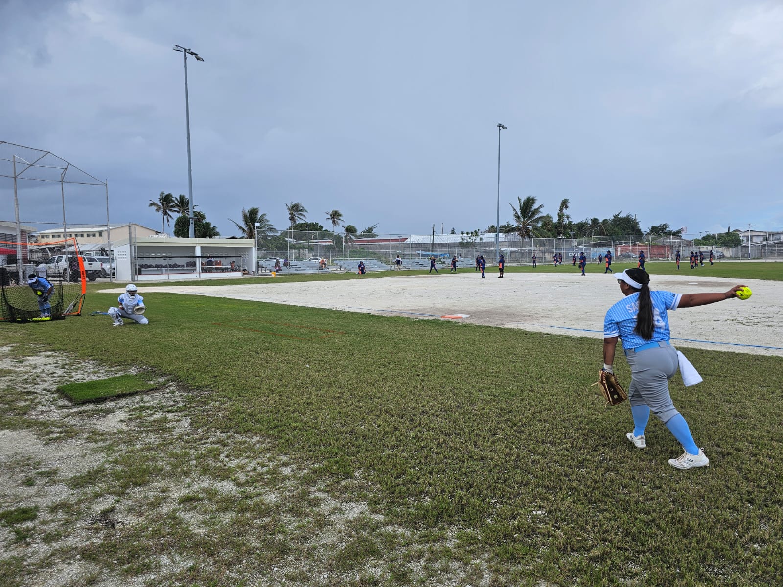 The NMI Women’s Fast-Pitch Softball Team players warm up before their opening game against  the Marshall Islands.