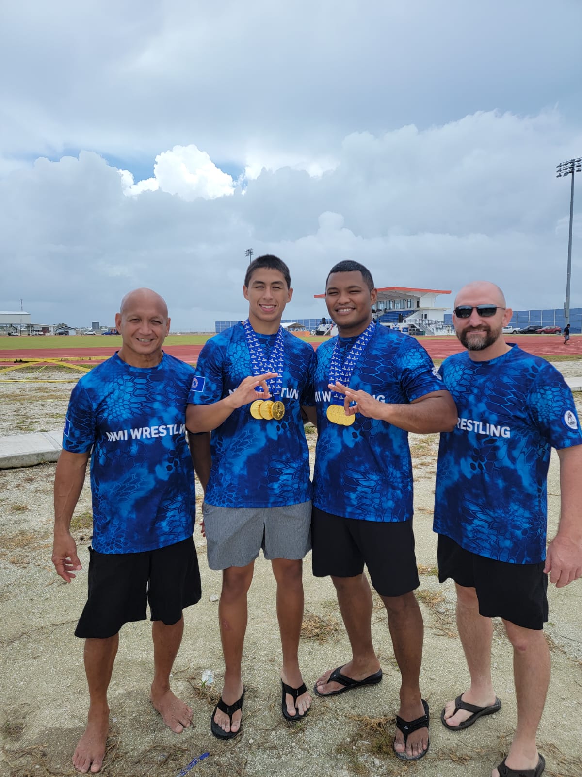 From left, Jason Tarkong, James Attao-Greene Jr., Ryan Babauta, and Rick Bauer are all smiles following the team’s triumph in beach wrestling competition in the 2024 Micronesian Games in the Marshall Islands Monday morning.