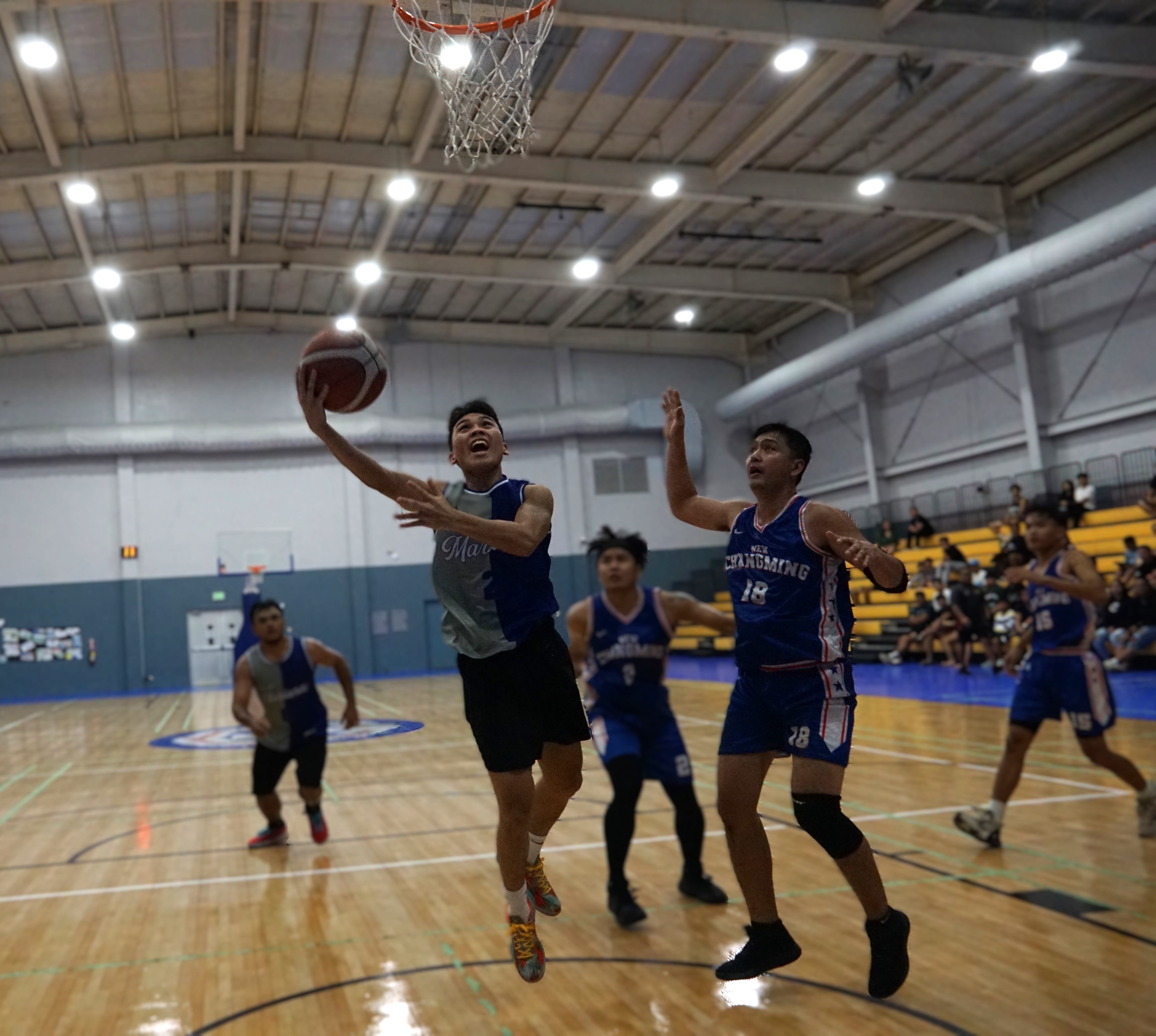 Team Marianas' Lucio Aldan goes up for the finish against New Changming in the championship game of the Michelob Ultra Cup at the Ada gym on Saturday. 