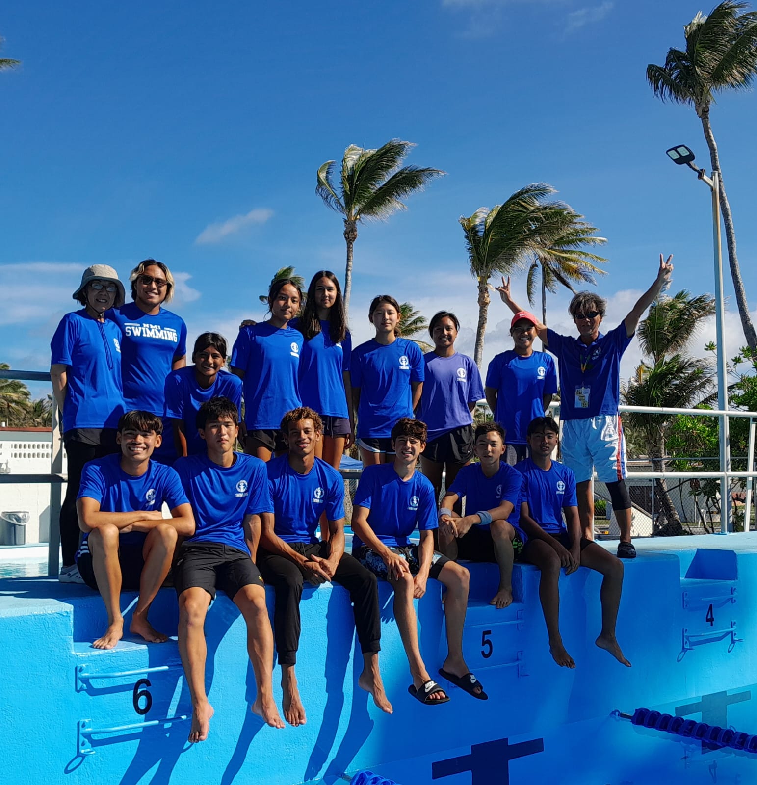 Team Marianas swimmers and coaches pose for a group photo before Thursday’s finals at the Kwajalein pool.