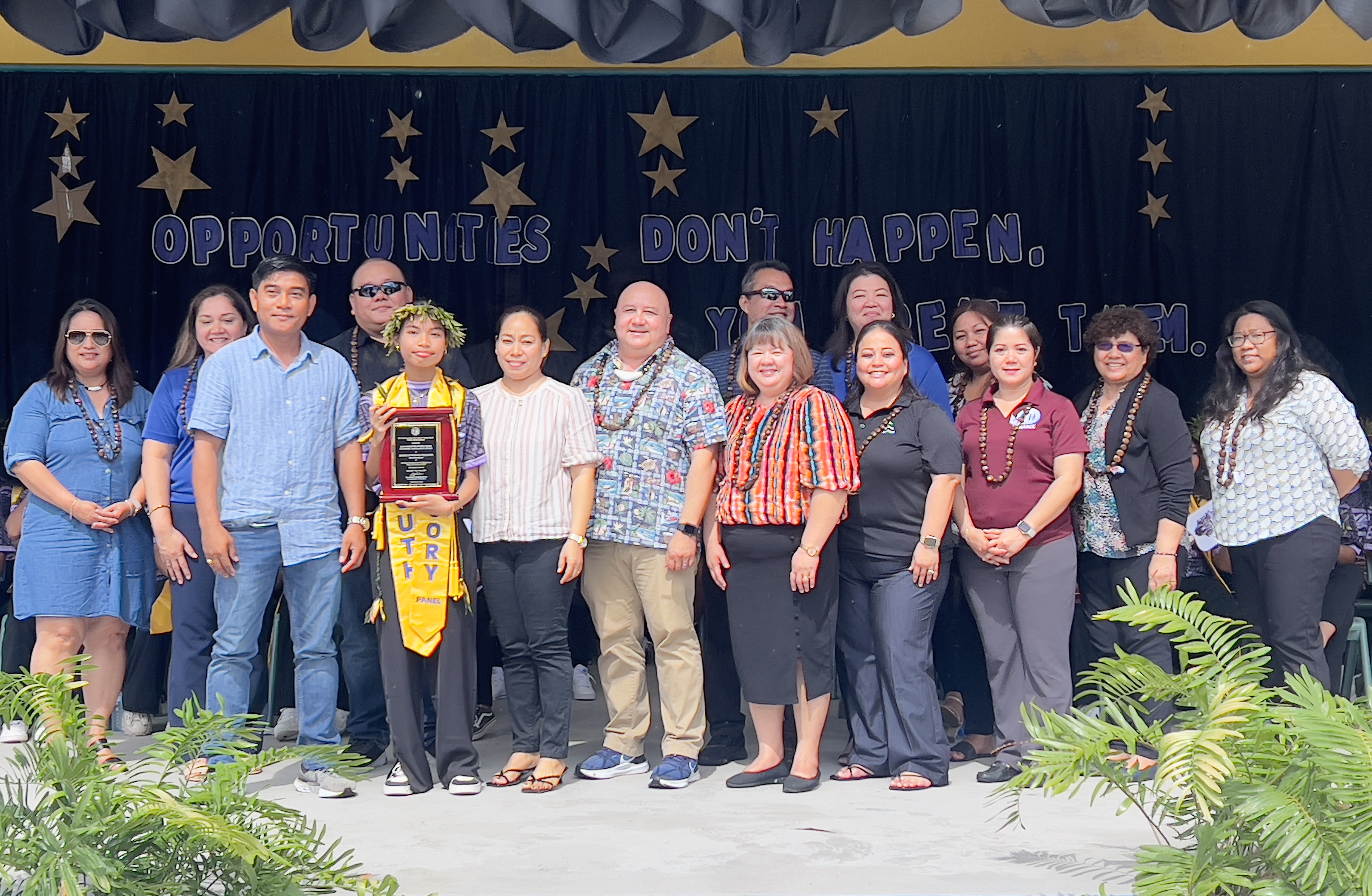 Class salutatorian Jashly G. Vilaspir is joined by her parents as she receives the Commissioner of Education Academic Excellence Award from by Commissioner of Education Dr. Lawrence F. Camacho and other PSS officials.