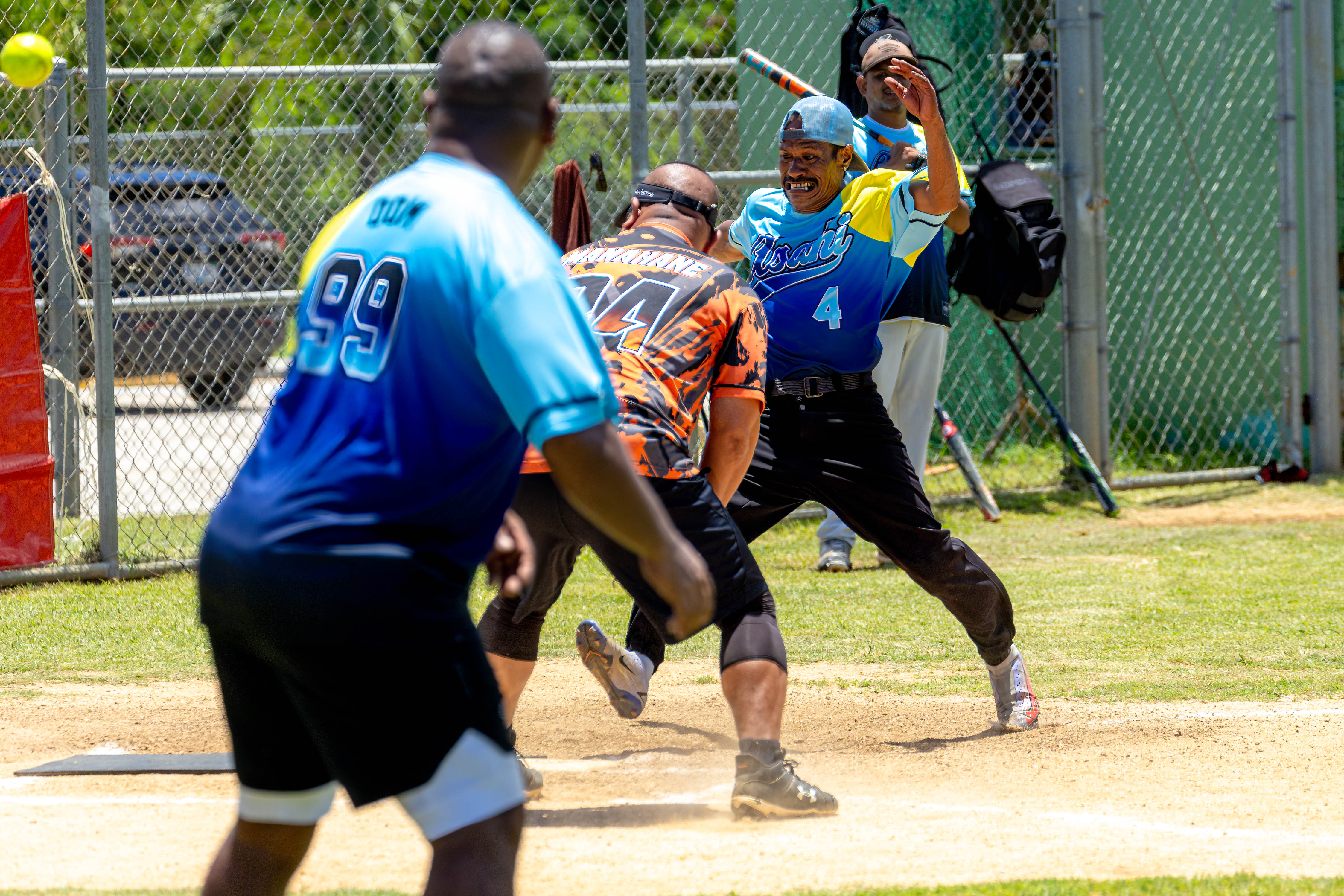 Asahi's Matsutaro sprints in as the ball flies past home plate for a run for his team.