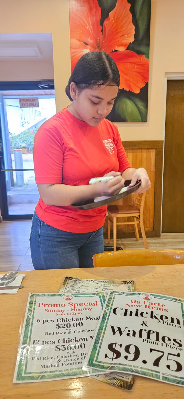 Cafe's staff member, Kira, diligently takes down an order.