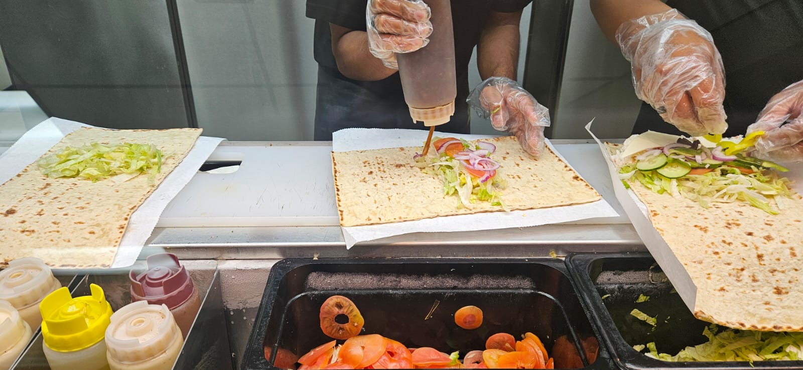Subway staff members prepare the wrap.