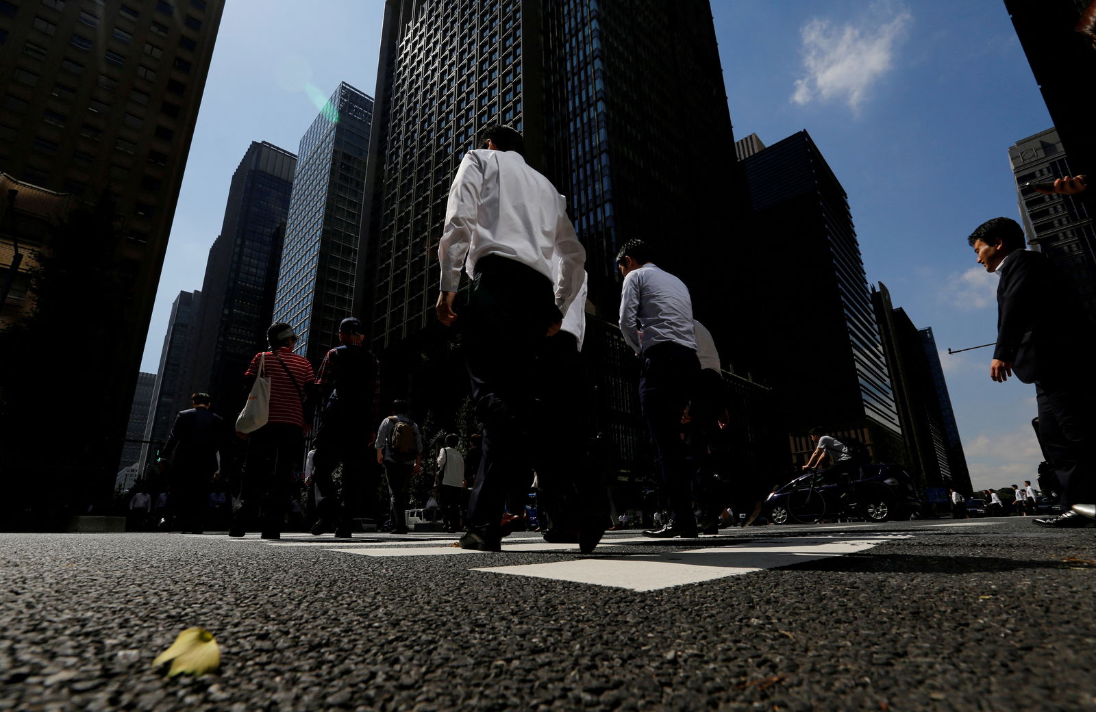 People walk on a crosswalk at a business district in central Tokyo, Japan, September 29, 2017.