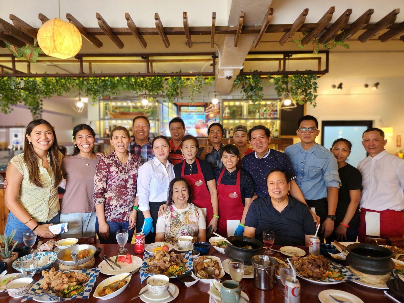 Bong and Malou Malasarte, owners and operators of Pepoy’s Café and Restaurant in Susupe, with daughters Amor and Angel and their staffers, pose for a photo with former Philippine President Gloria Macapagal-Arroyo and her husband, Jose Miguel “Mike” Tuason Arroyo