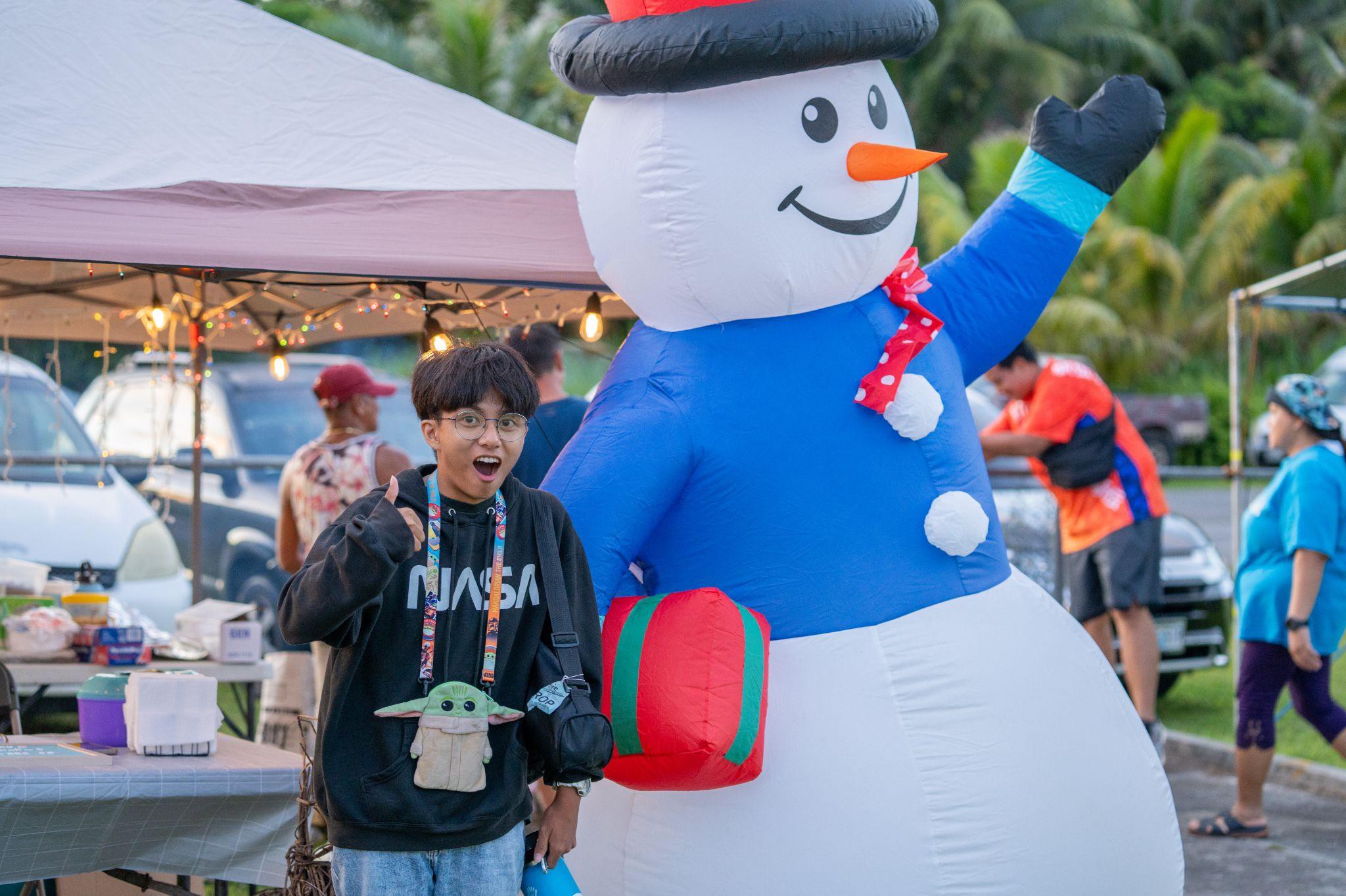 An event-goer poses for a cheerful photo at the Christmas in July event held Friday at the Sinapalo Children's Park.